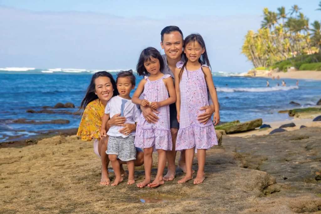 A family with three children smiling