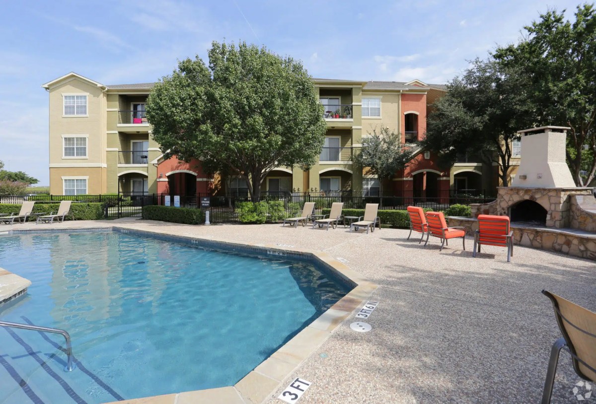 Apartment complex with swimming pool and outdoor fireplace