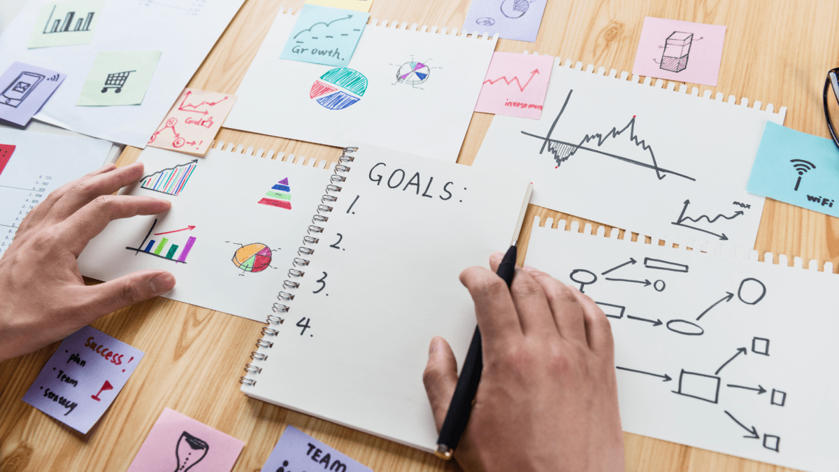 Writing down a list of goals to help aspire to determine your financial objectives or long-term financial goals